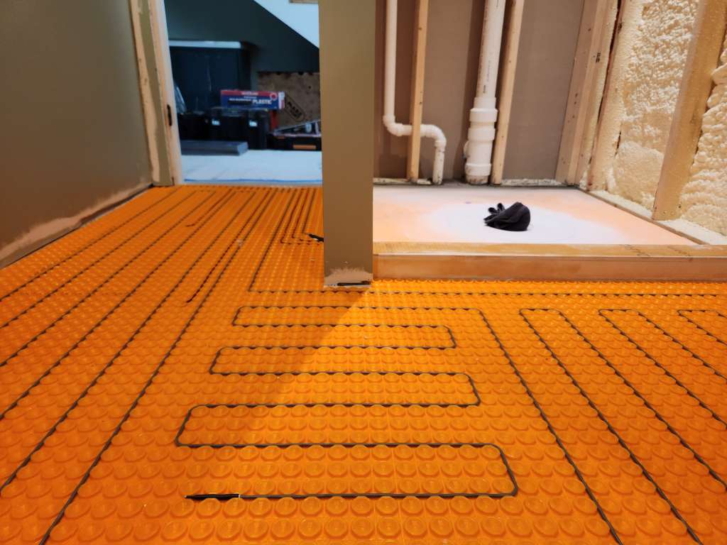 Radiant heated floor installation winter construction custom bathroom maine