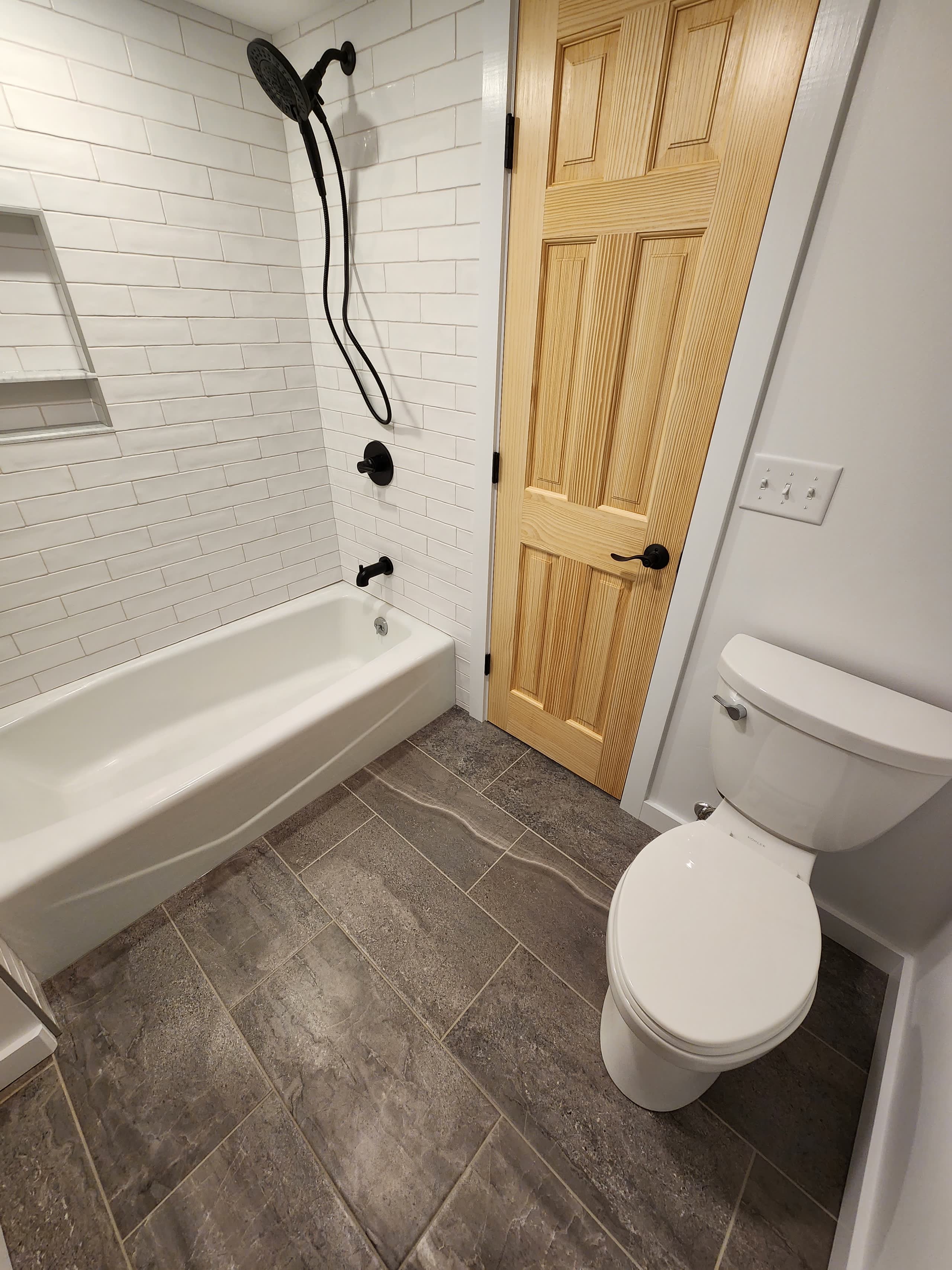 Remodeled bathroom with new tub and vanity by Winter Construction in Western Maine