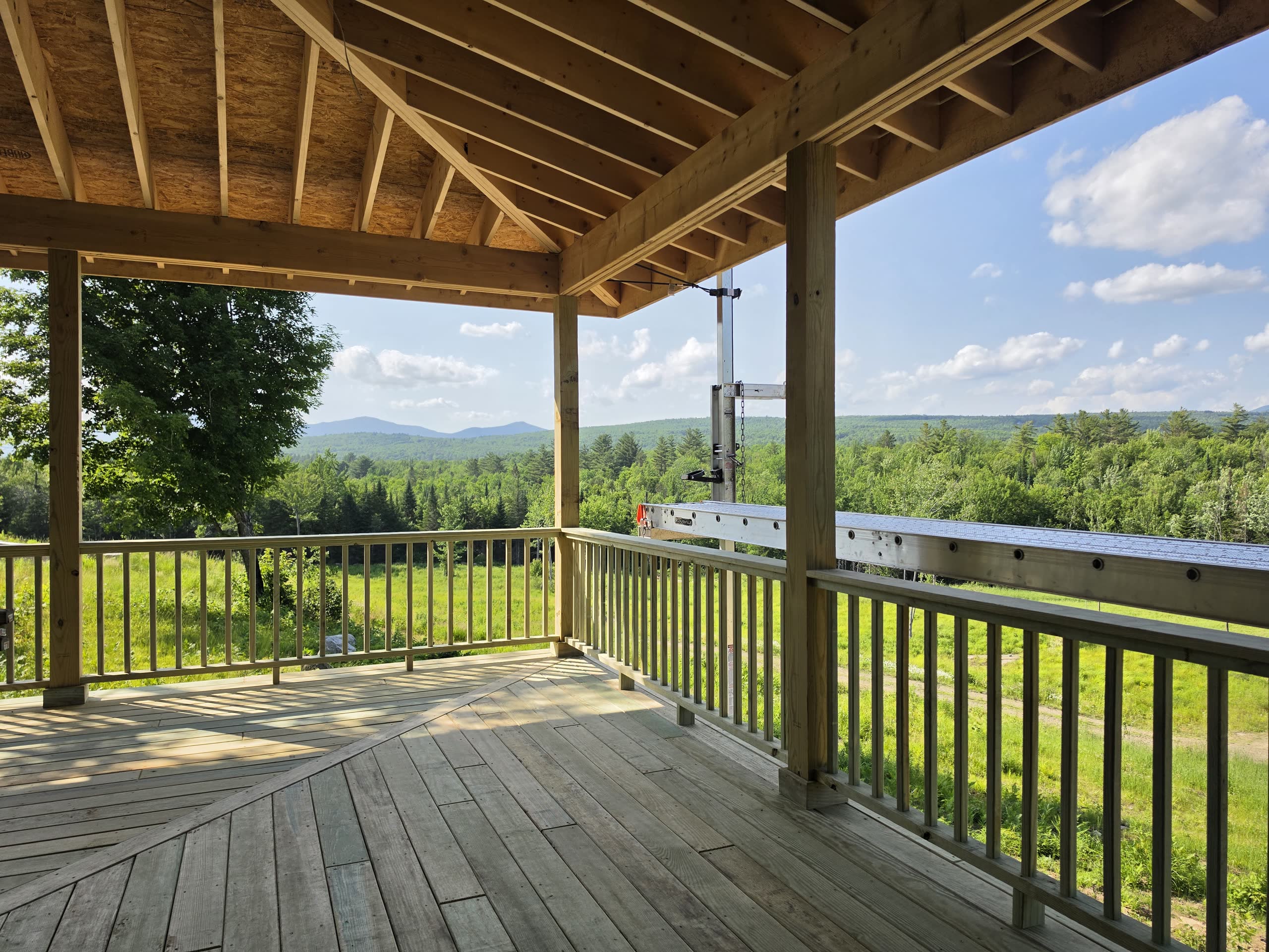 Custom home build in progress with finished porch in Phillips, Maine