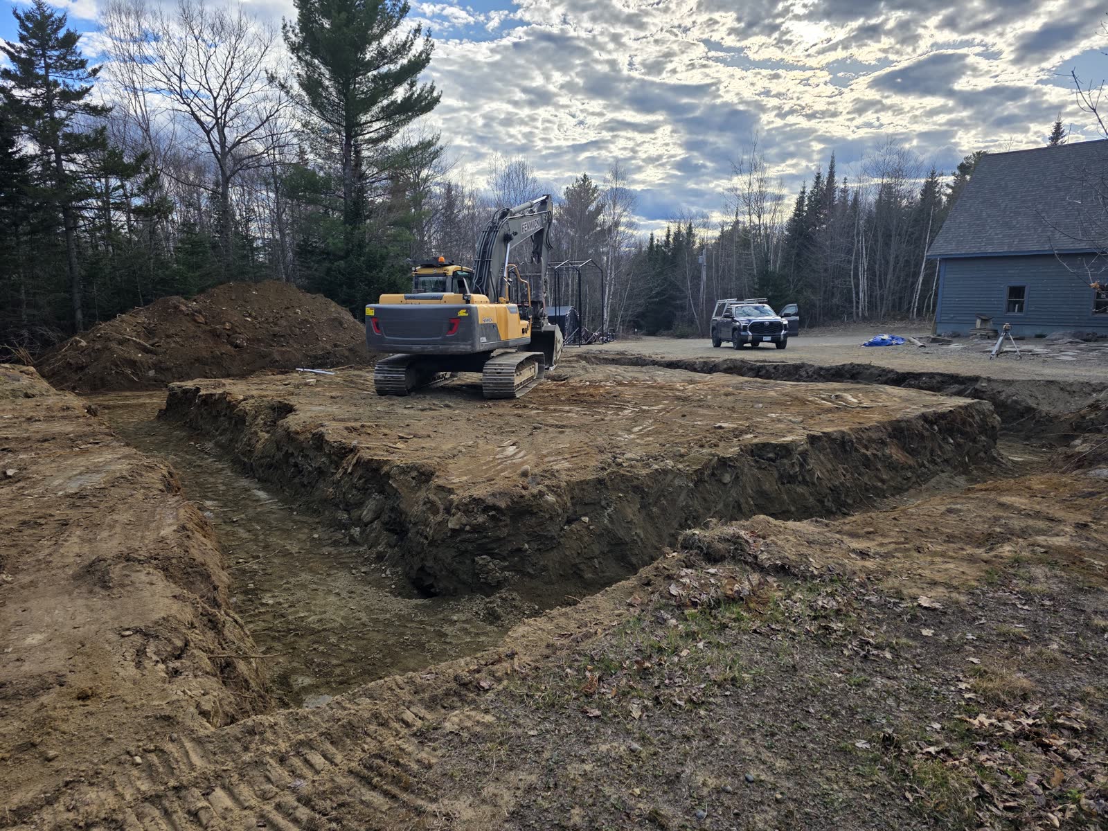 Excavating the footprint at a Winter Construction garage build in Western Maine