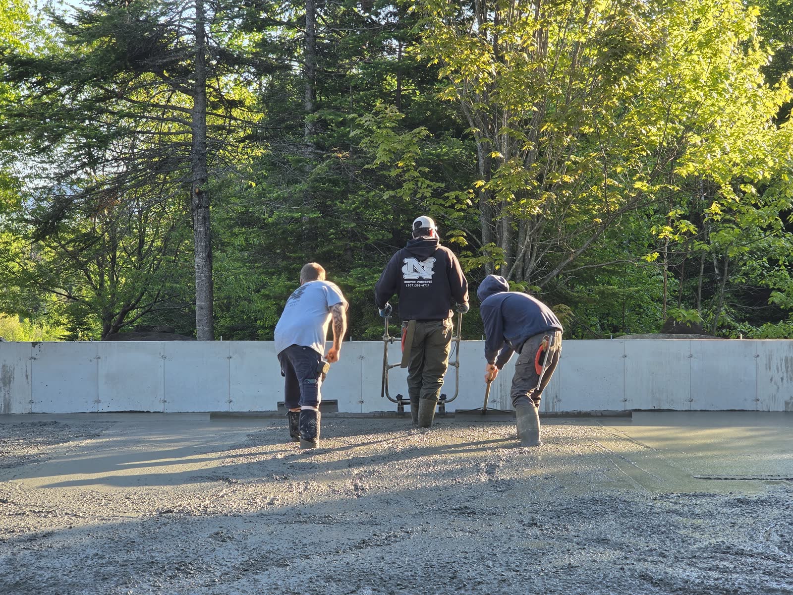 Finishing the slab at a Winter Construction garage build in Western Maine