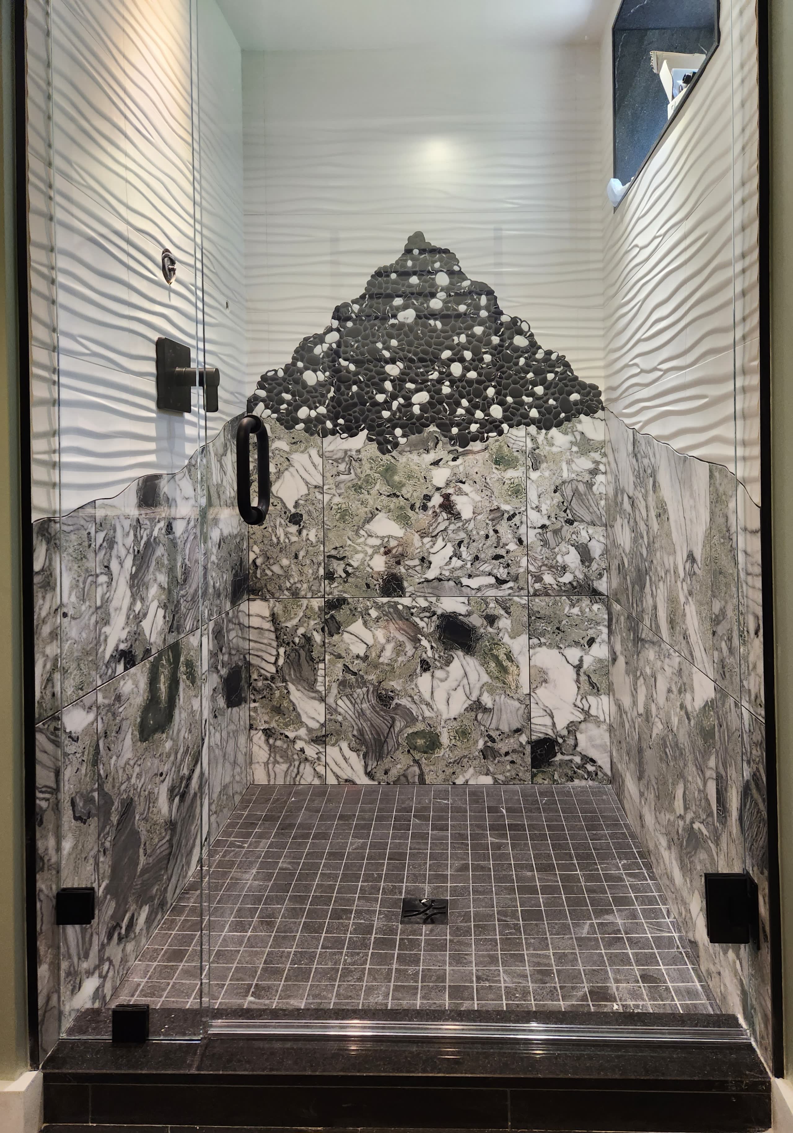 Custom pebble mosaic mountain shower by Winter Construction