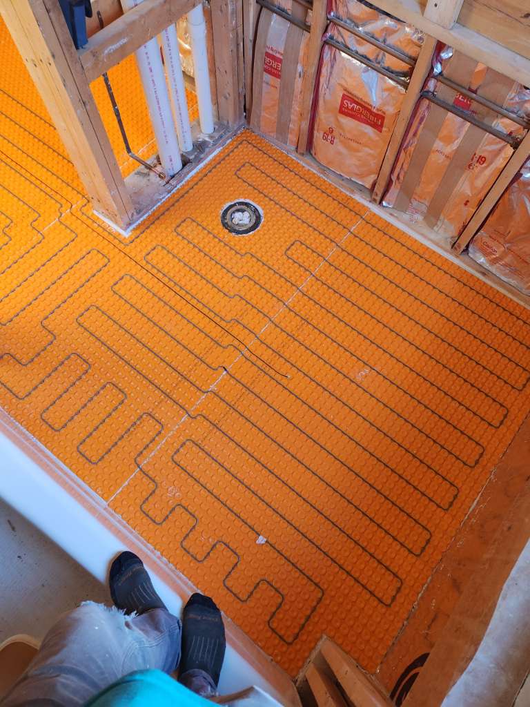 Ditra heat radiant floor membrane winter construction bathroom remodel maine