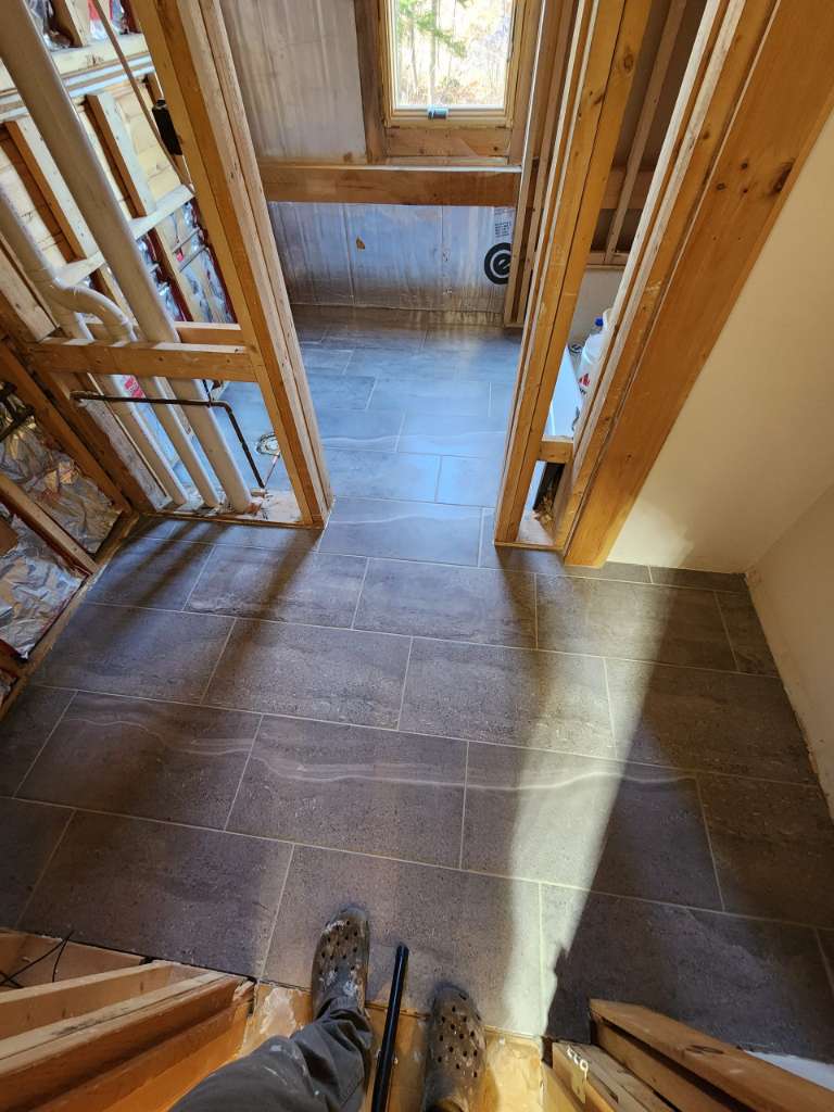 Finished bathroom tile floor winter construction bathroom remodel maine
