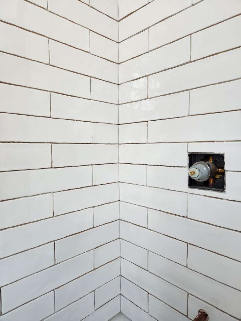 White subway tile surround winter construction bathroom remodel maine