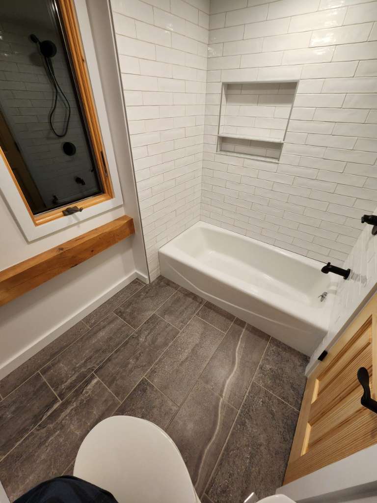 Tiled tub surround window winter construction bathroom remodel maine