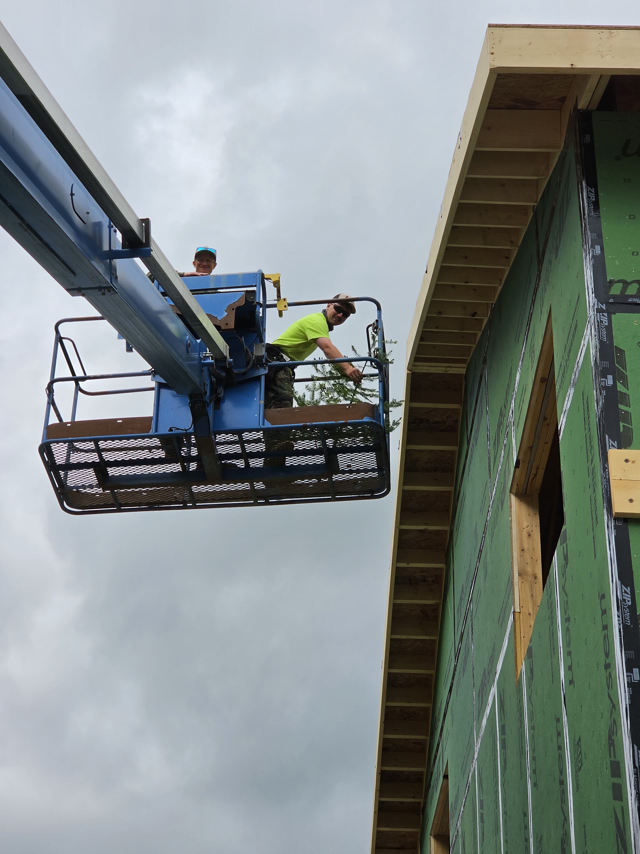 Winter Construction crew in a boom lift framing a building